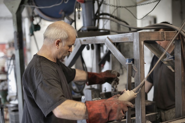 A Old Worker holds a Machine |